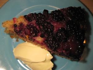 Slice of blackberry upside down cake served with creme fraiche